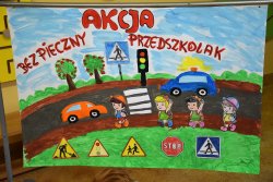 rysunek przedstawiający dzieci idące przy ulicy, przy której poruszają się pojazdy