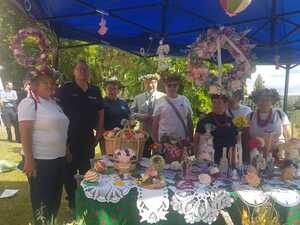 umundurowany policjant z seniorami pod namiotem przed stoiskiem