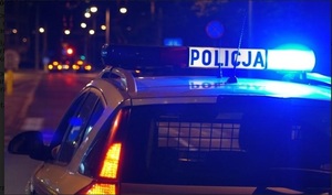 oznakowany radiowóz wieczorem z włączonymi światłami uprzywilejowania