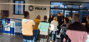 osoby stoją w Komendzie przed nimi umundurowani policjanci