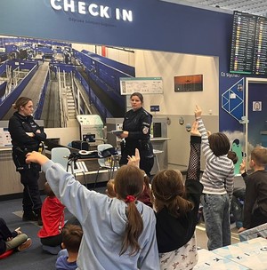 umundurowane policjantki przed nimi dzieci