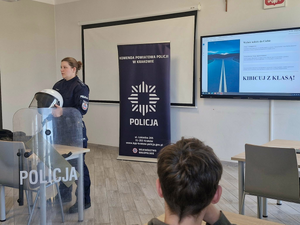 policjantka prezentuje uczniom wyposażenie policjantów