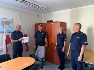 policjantka i trzech policjantów w mundurach w gabinecie podczas oficjalnego powierzenia obowiązków