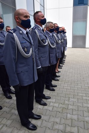 rząd stojących awansowanych policjantów bokiem