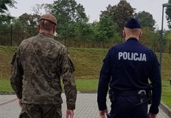 wspólny patrol policjant i żołnierz, ustawieni tyłem